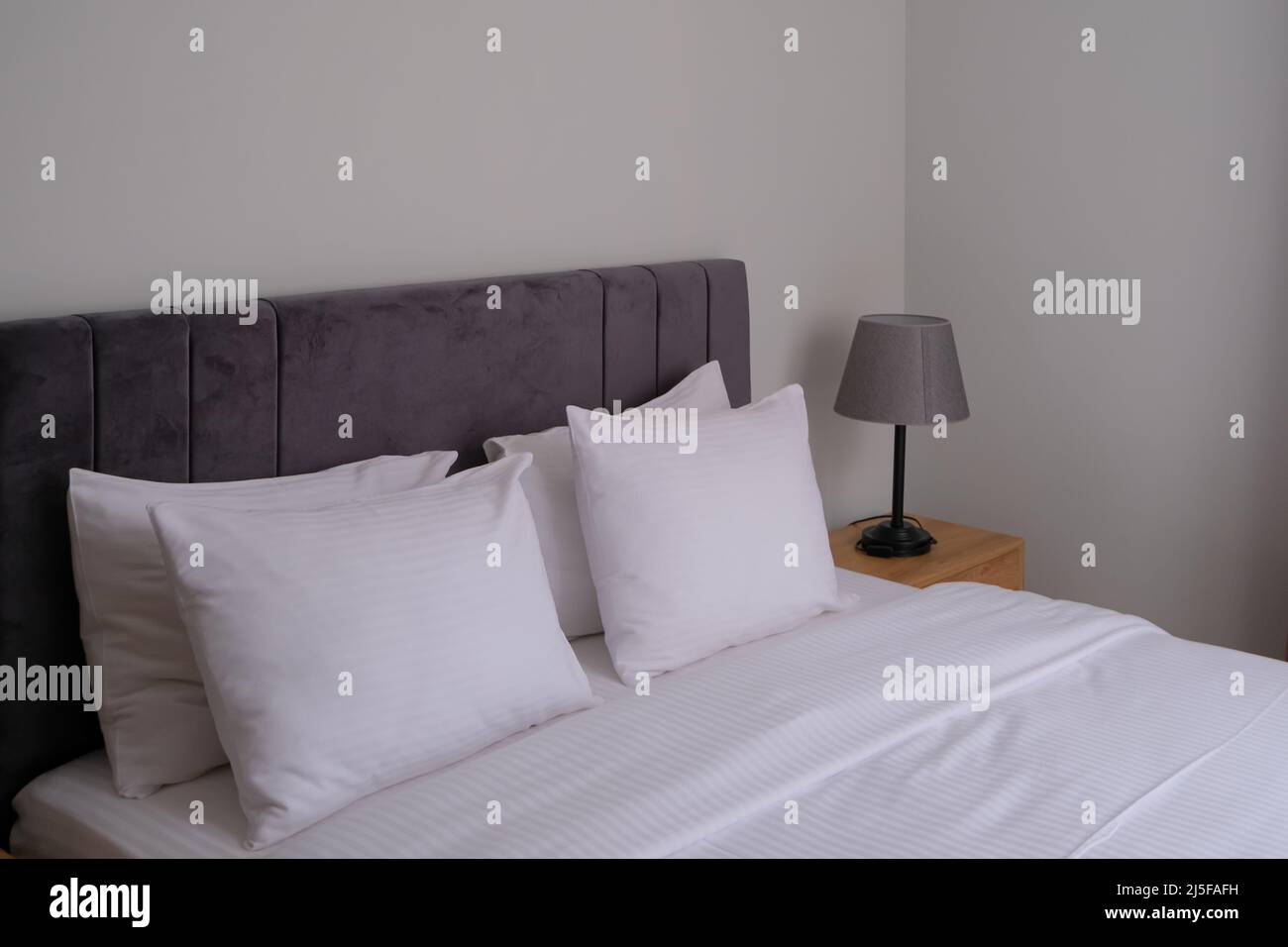 clean modern bedroom with white bedding. minimal interior. good sleep
