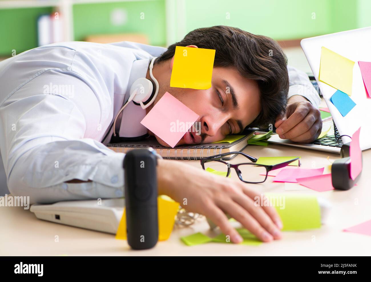 Young help desk operator working in office with many conflicting