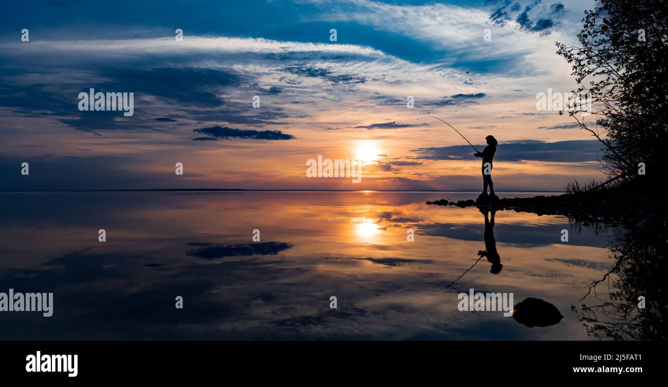 Woman fishing on Fishing rod spinning in Finland Stock Photo