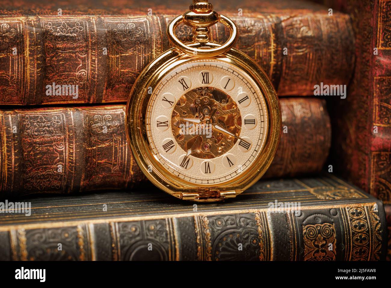 Vintage Antique pocket watch on the background of old books Stock Photo