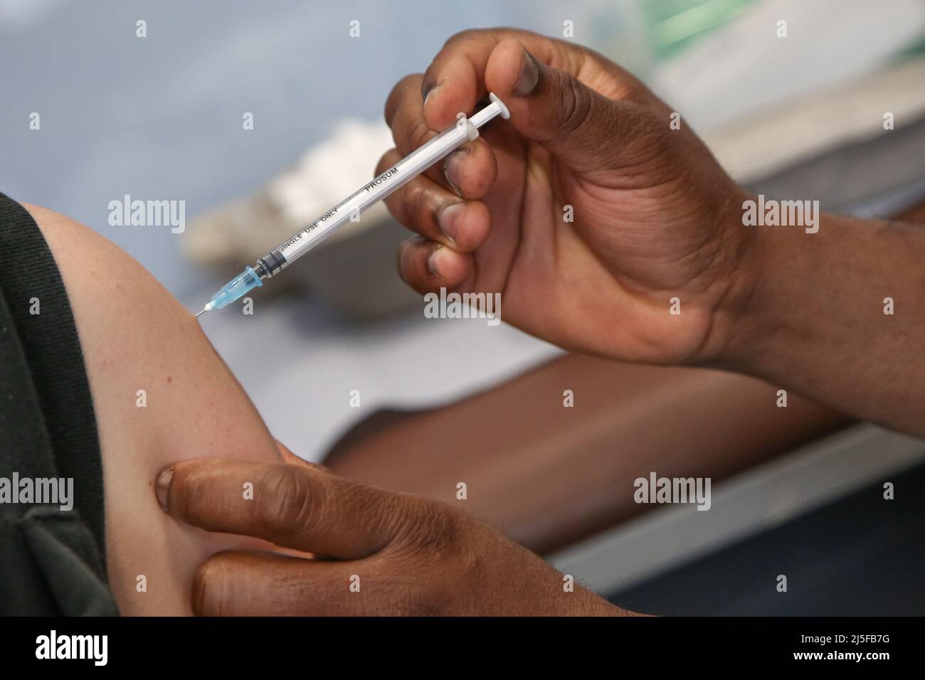 London, UK 22 Apr 2022 - A NHS vaccinator, administers the Moderna spring COVID-19 booster (fourth jab) to person at a vaccination centre. Credit Dinendra Haria /Alamy Live News Stock Photo