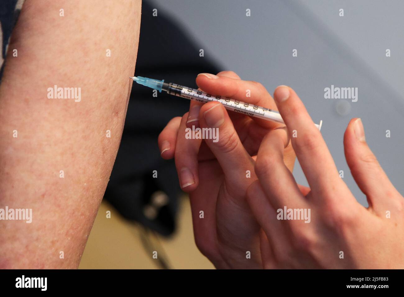London, UK 22 Apr 2022 - A NHS vaccinator, administers the Moderna spring COVID-19 booster (fourth jab) to person at a vaccination centre. Credit Dinendra Haria /Alamy Live News Stock Photo
