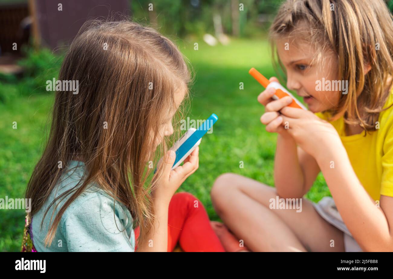 Small kids,girls play in walkietalkie.Walkie Talkies with channels.Game of detectives, spies