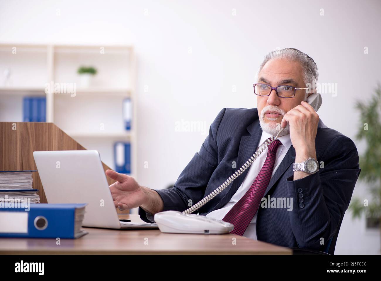 Old employee and too much work in the office Stock Photo Alamy