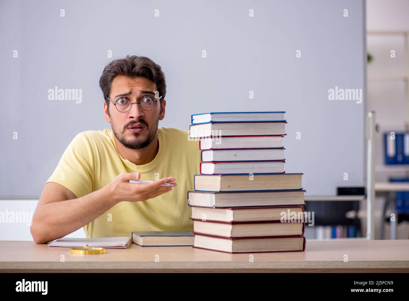 Young student preparing for exams in the classroom Stock Photo - Alamy