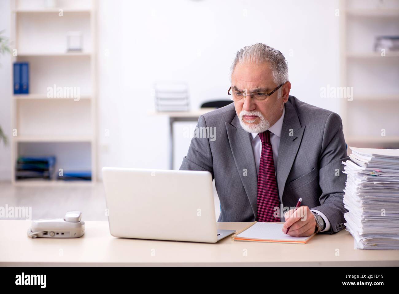 Old employee and too much work in the office Stock Photo Alamy