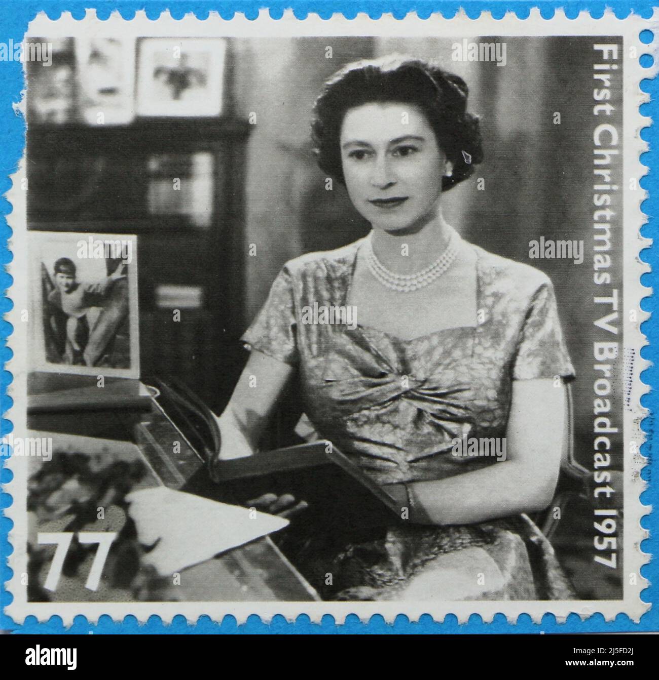 Photo of a stamp issued for Queen Elizabeth II Diamond Jubilee in 2012 featuring a black and white image of her first Christmas tv broadcast in 1957 Stock Photo