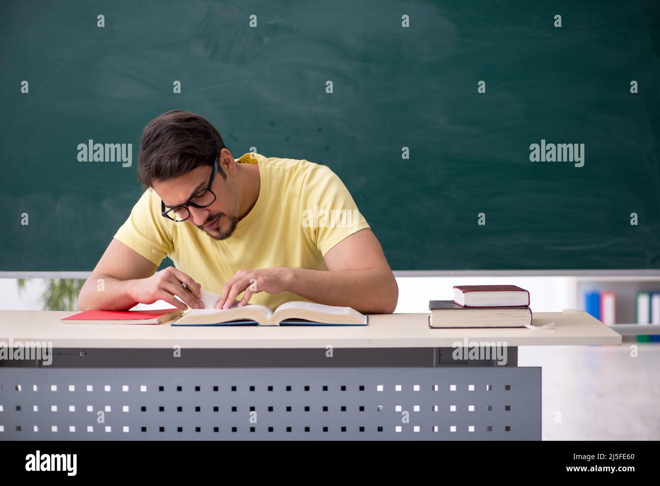 Front Student Young student in front of blackboard Stock Photo - Alamy