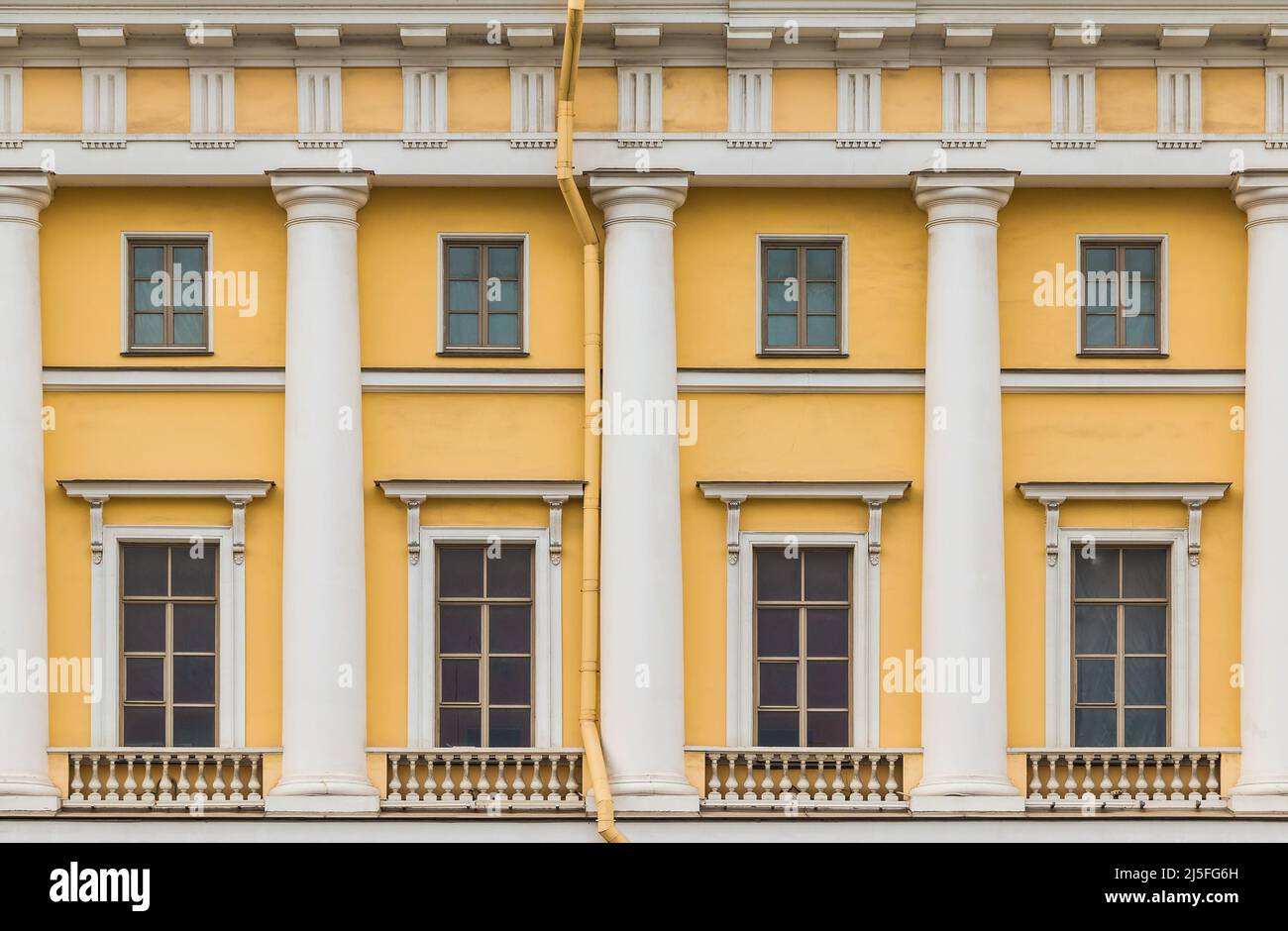 Columns and several windows in a row on the facade of the urban historic apartment building front view, Saint Petersburg, Russia Stock Photo