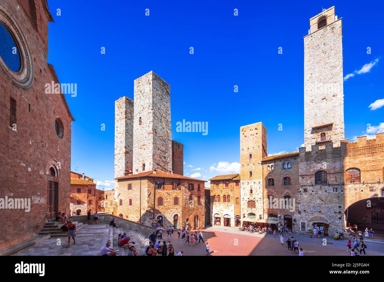 San Gimignano, Italy - September 2021. Tourists in Piazza del Duomo, San Gimignano (Italy) the famous small walled medieval hill town in the province Stock Photo