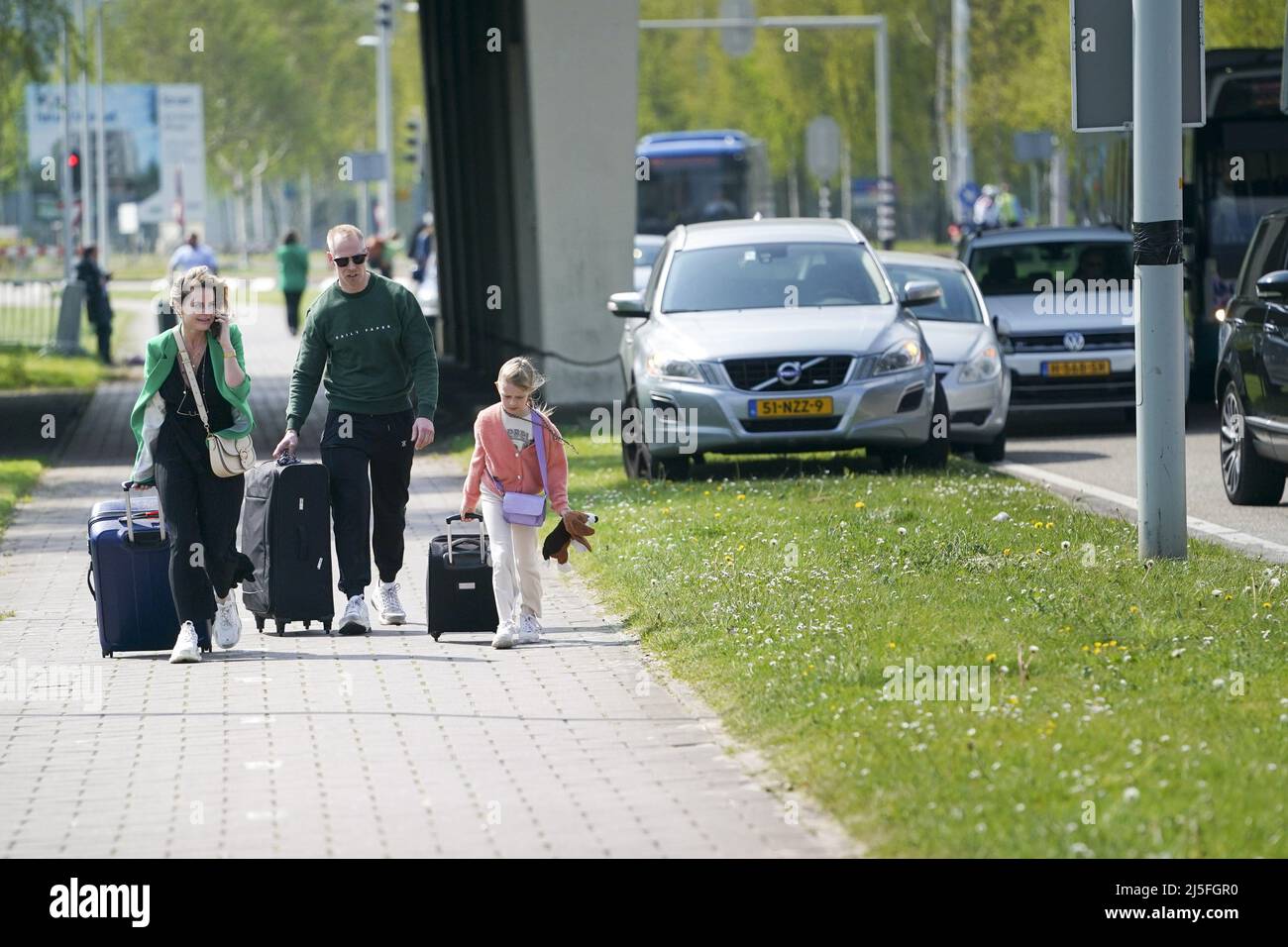 Schiphol, Netherlands. 23rd Apr, 2022. 2022-04-23 12:23:18 SCHIPHOL - Travelers walk with their suitcases towards Schiphol Airport. Due to the strike at Schiphol and the accompanying safety reasons, the exits at Schiphol of the A4 motorway are closed. ANP JEROEN JUMELET netherlands out - belgium out Credit: ANP/Alamy Live News Stock Photo