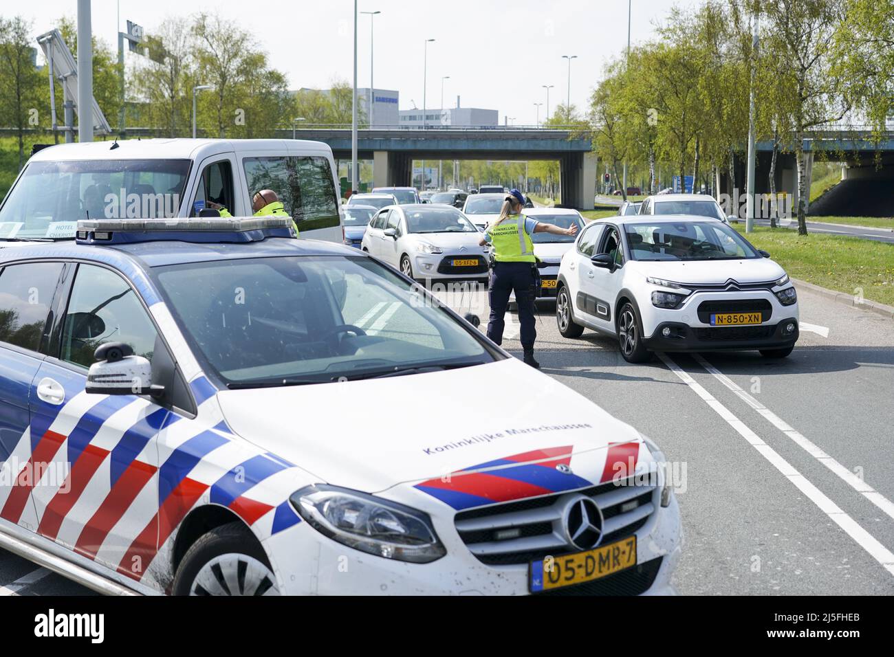 Schiphol, Netherlands. 23rd Apr, 2022. 2022-04-23 12:15:29 SCHIPHOL -  Employee of the Marechaussee keep the traffic around Schiphol in the right  direction. Due to the strike at Schiphol and the accompanying safety