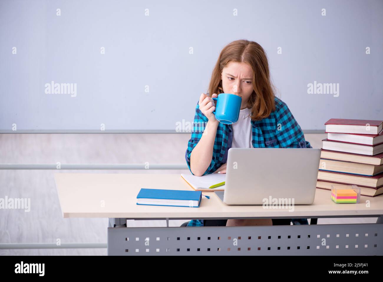 Young girl student drinking coffee during break Stock Photo Alamy