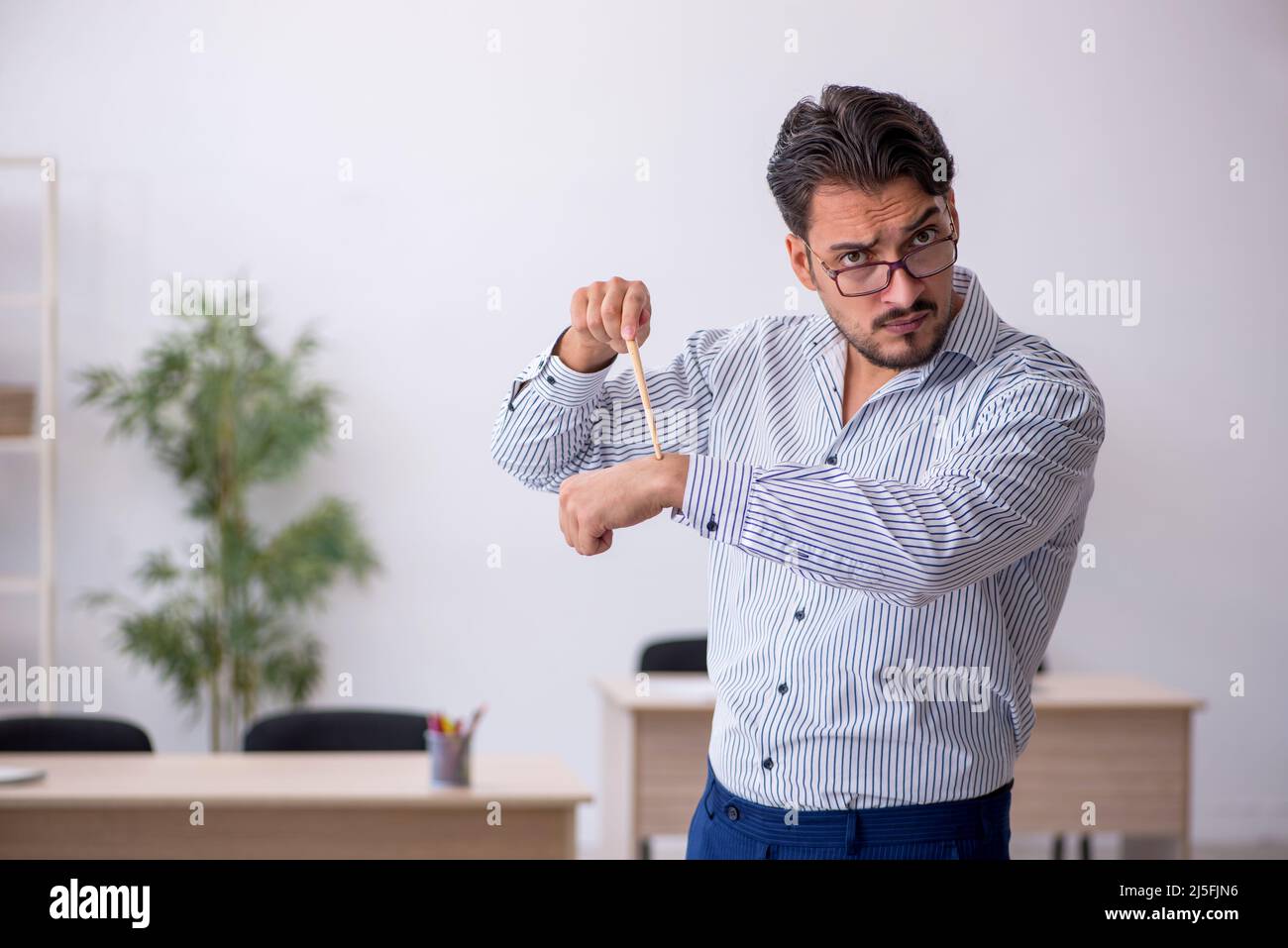 Young teacher in time management concept Stock Photo Alamy