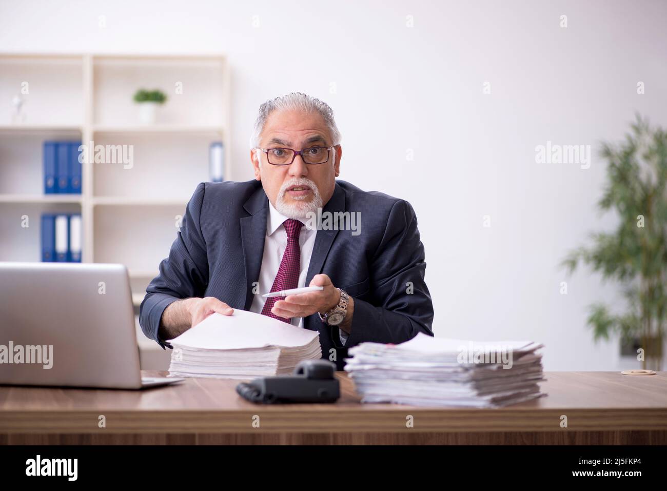 Old employee and too much work in the office Stock Photo Alamy