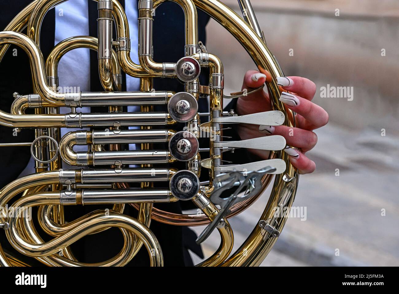 Woman's hands playing a horn or French horn, in the orchestra Stock