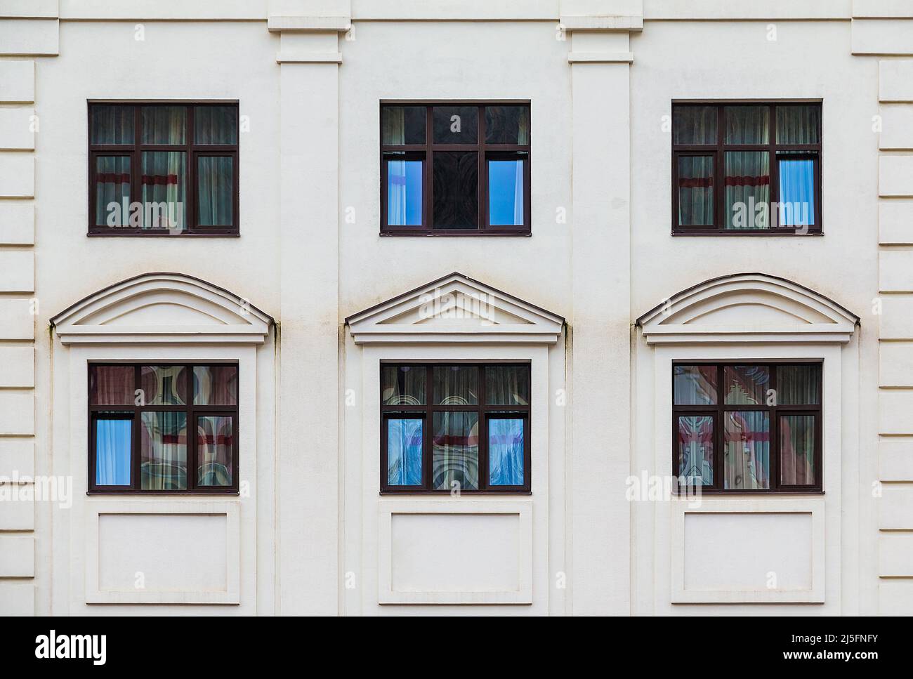 Several windows in a row on the facade of the modern urban apartment building front view, Krasnaya Polyana, Sochi, Krasnodar Krai, Russia Stock Photo