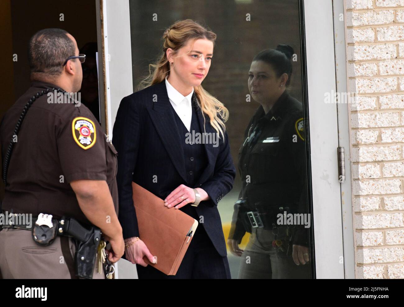 Amber Heard enters her truck as she departs following day 8 of her