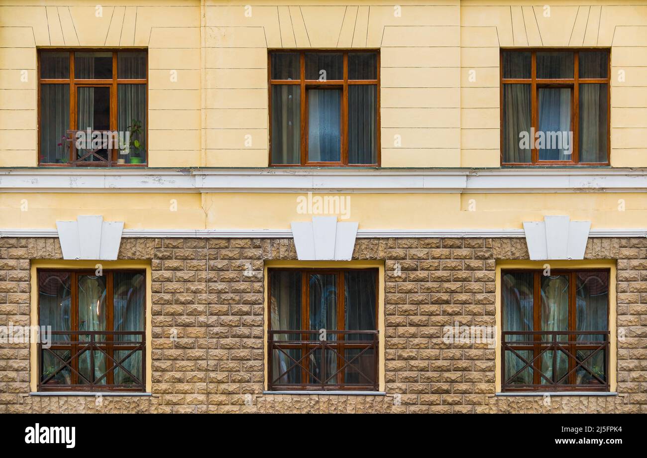 Several windows in a row on the facade of the modern urban apartment