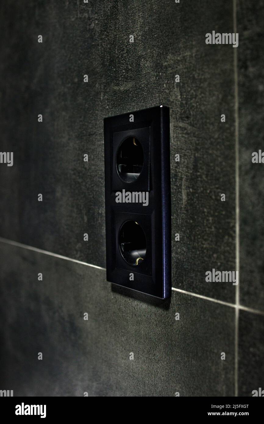 New black rosette on a ceramic tile of black color. Electrical outlet. Bathroom Stock Photo - Alamy