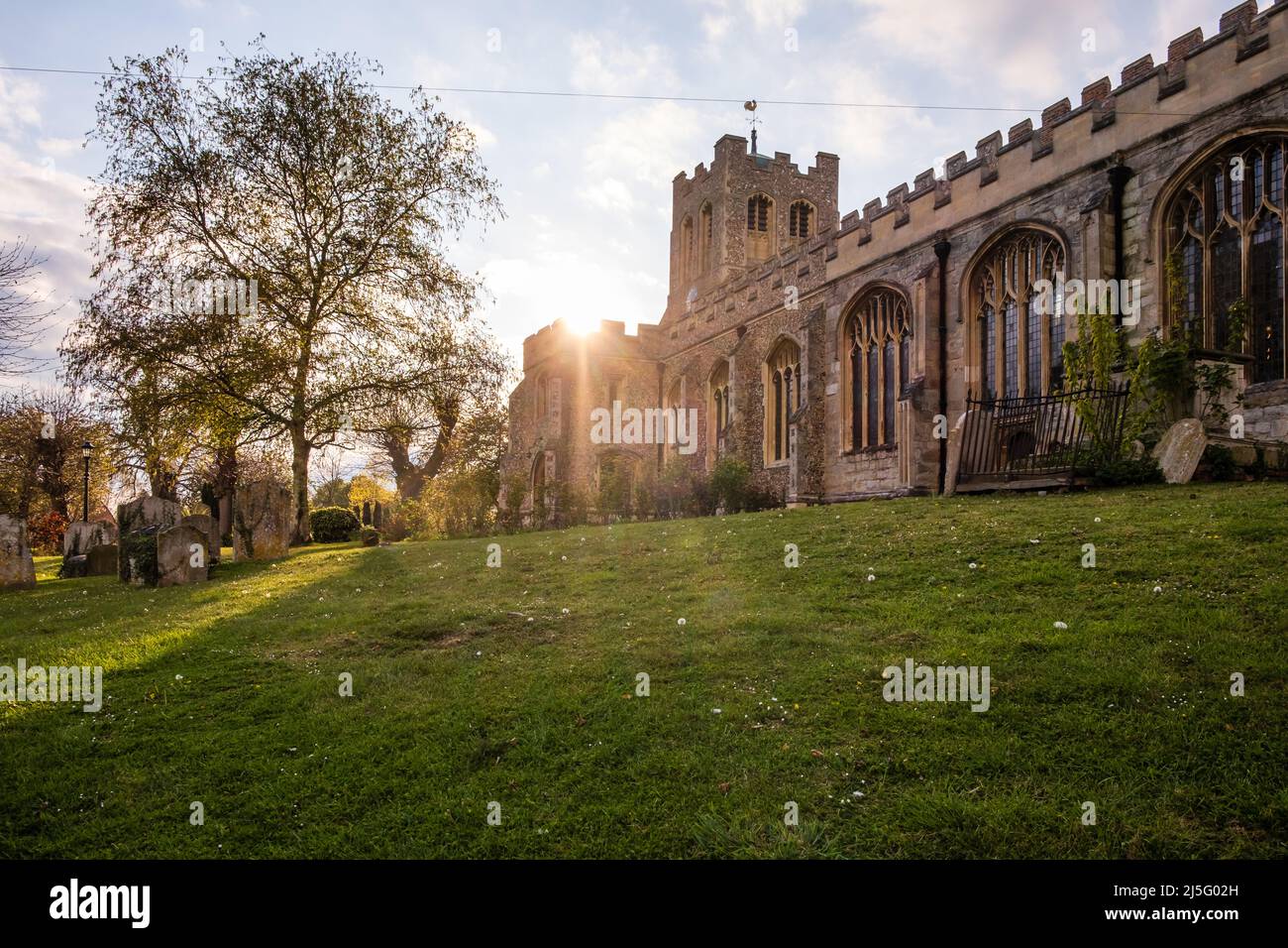 Sun setting over the Anglican Church of St. Peter ad Vincula in the Essex village of Coggeshall. Stock Photo
