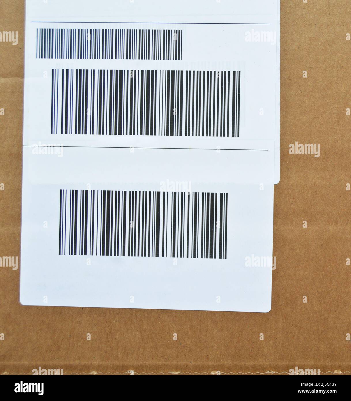 Brown and beige cardboard paper mail envelope on sticky barcodes. Can