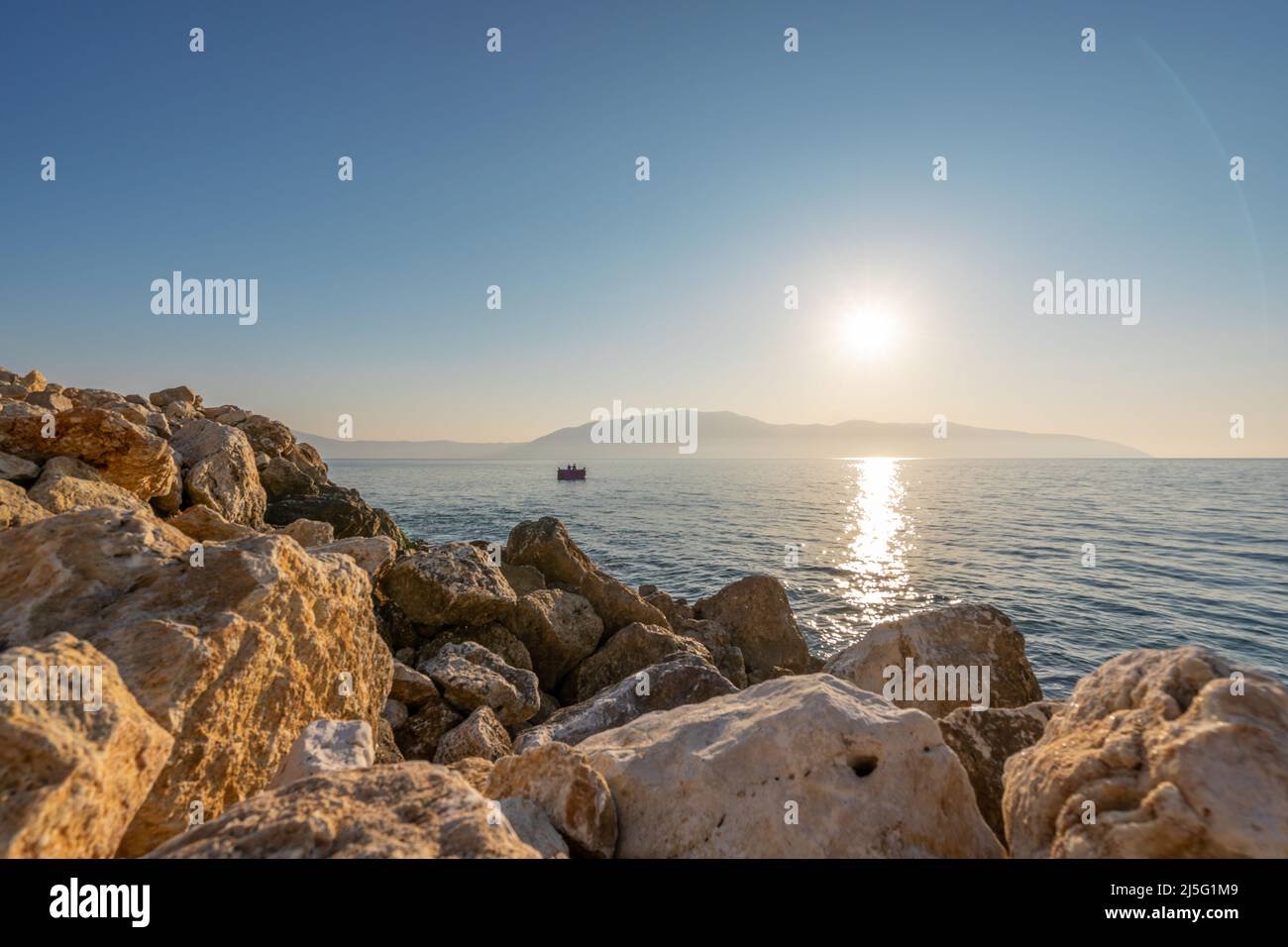 Sunset at rocky stone beach in Albania. Adriatic sea, peninsula