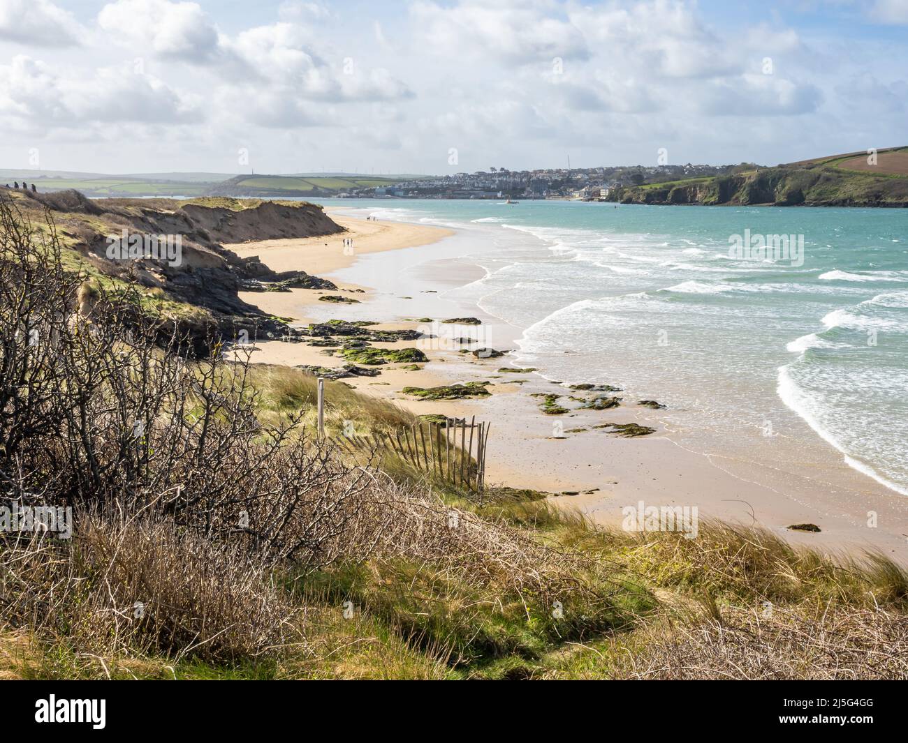 Rock beach and the Camel estuary with Padstow in the background, on a windy day viewed from the coastal path. Stock Photo