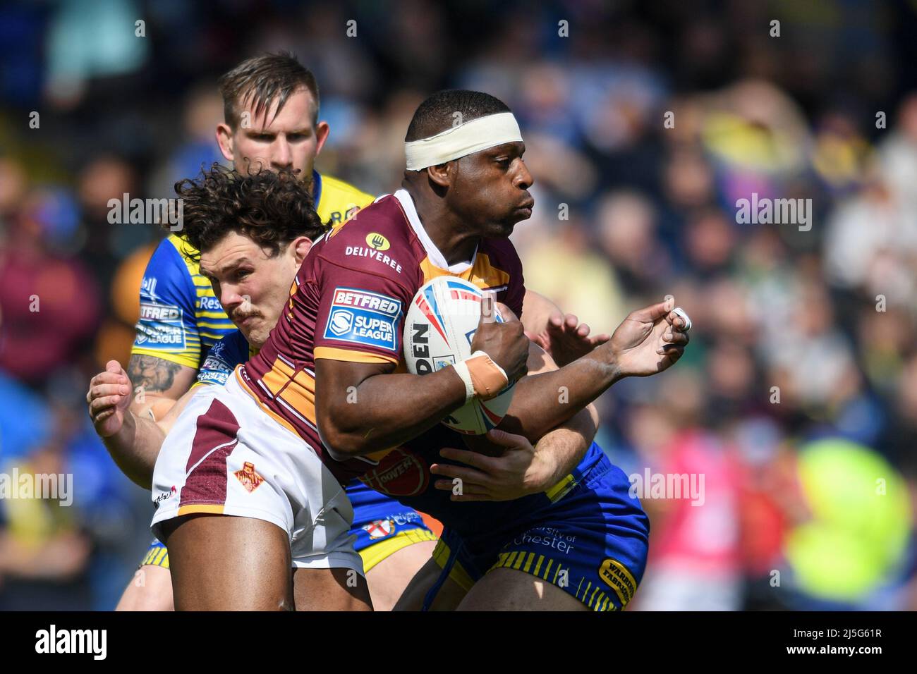 Warrington, UK. 23rd Apr, 2022. Jermaine McGillvary #2 of Huddersfield Giants is tackled by Rob Mulhern #19 of Warrington Wolves in Warrington, United Kingdom on 4/23/2022. (Photo by Simon Whitehead/News Images/Sipa USA) Credit: Sipa USA/Alamy Live News Stock Photo