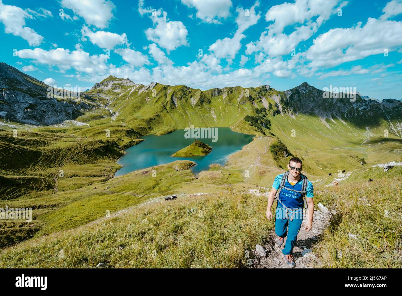 Man is hiking around lake Schrecksee in the bavarian alps Stock Photo