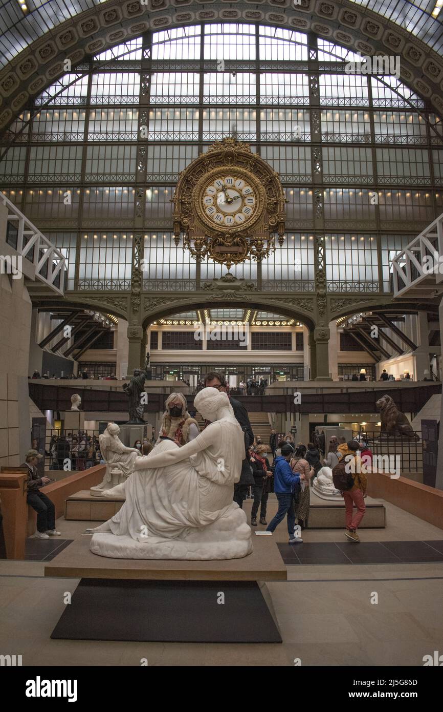 Paris clock, sculptures and crowd in the main hall of Musee d'Orsay