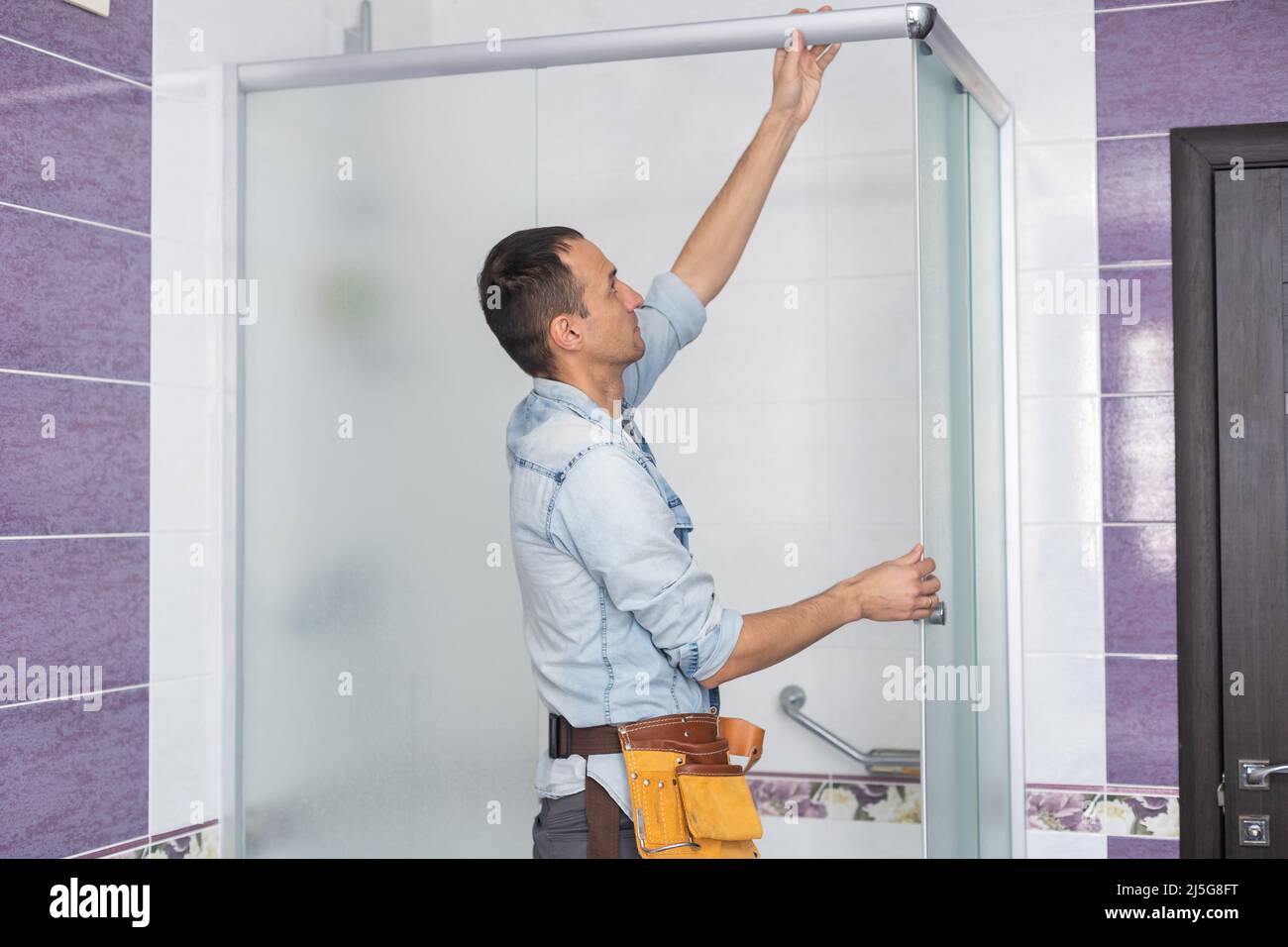Plumber installing a shower cabin in bathroom stock photo alamy