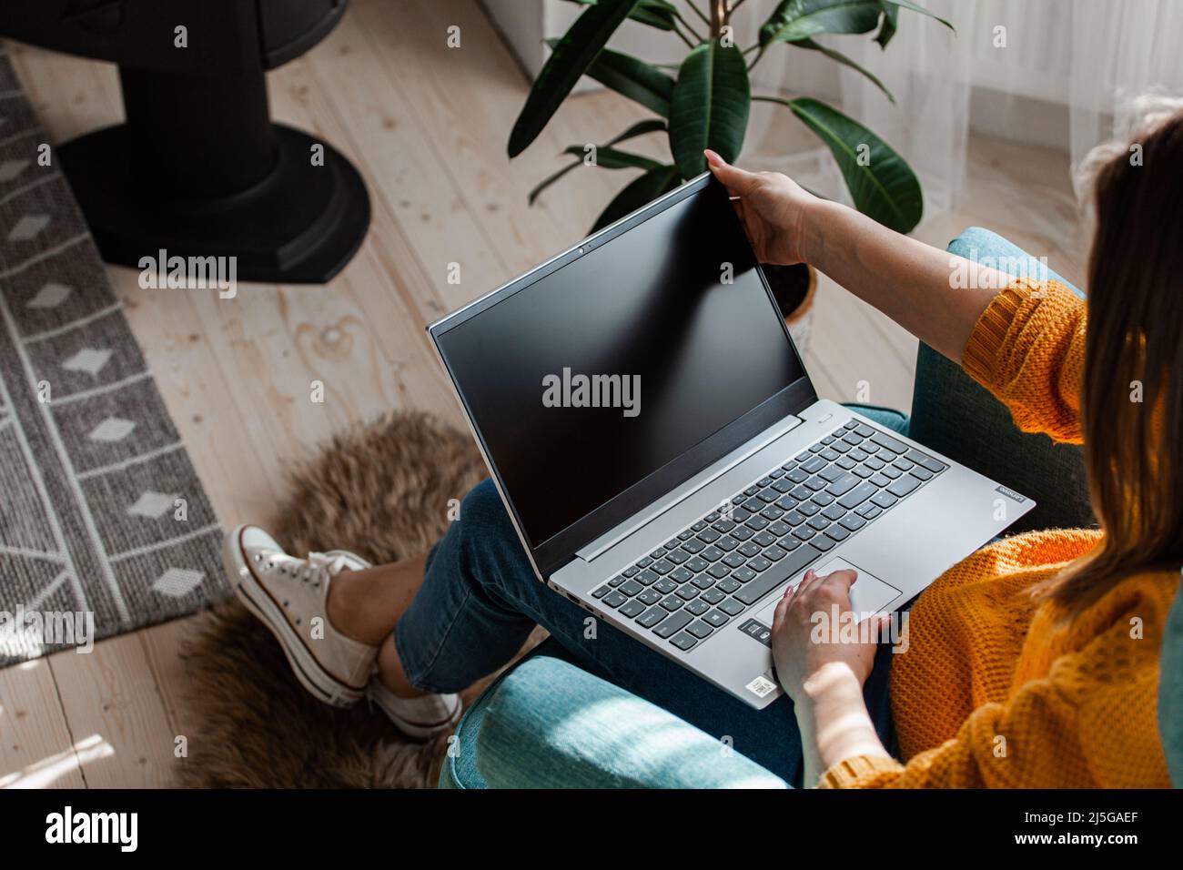 Young woman using laptop to work home, remote work Stock Photo