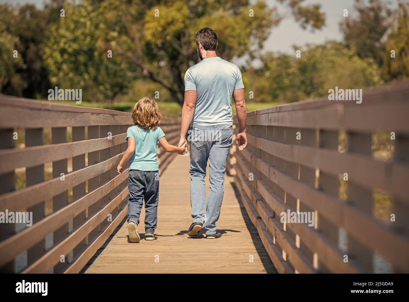 fathers day. father and son walking outdoor back view. family value. childhood and parenthood. Stock Photo