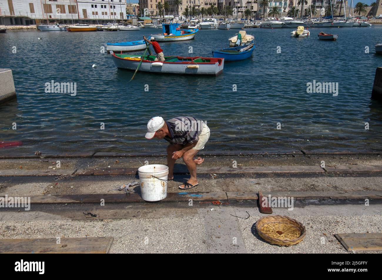 Bari, Italy 11/07/2005: fisherman on the pier. © Andrea Sabbadini Stock Photo