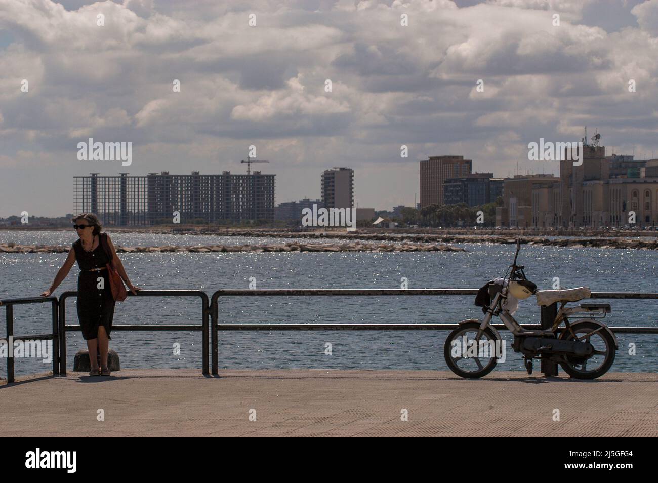 Protti Bari Bari, Italy 11/07/2005: woman on the pier, Punta Perotti building ...