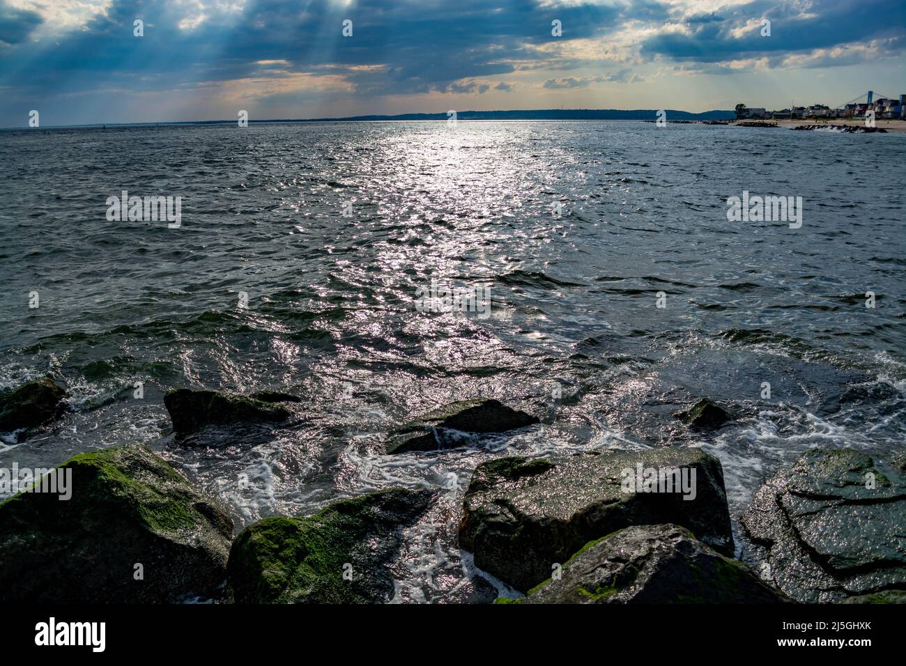 Waves splashing on the stones at the beach Stock Photo - Alamy