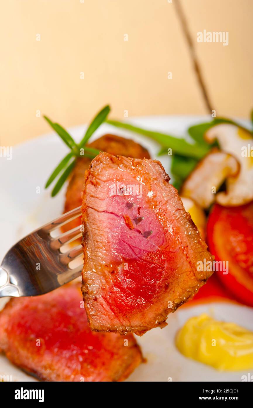 beef filet mignon grilled with fresh vegetables on side ,mushrooms