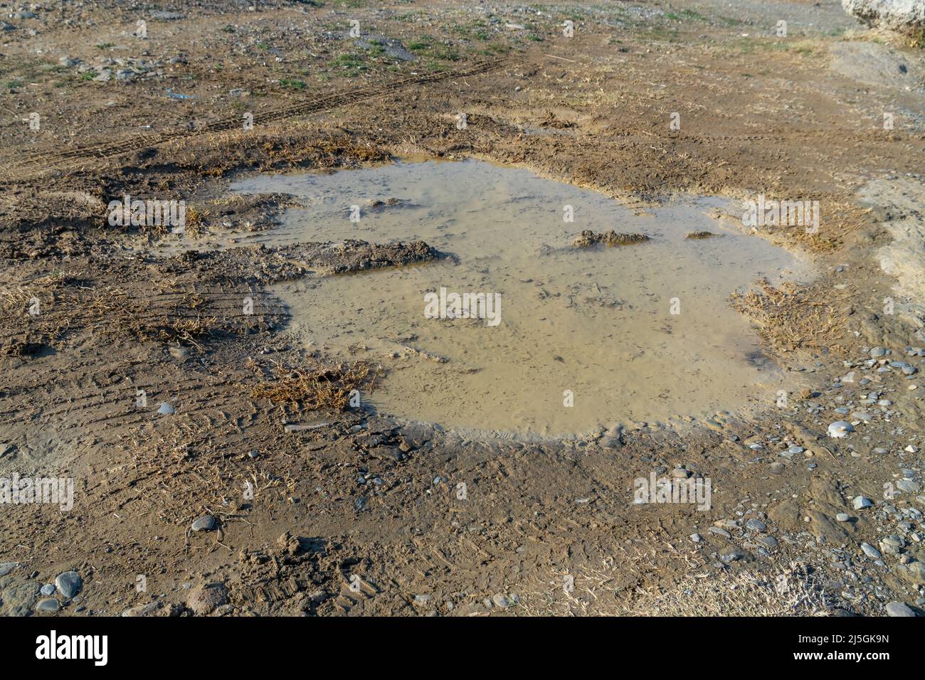A bumpy wet gravel road after the rain, texture Stock Photo - Alamy