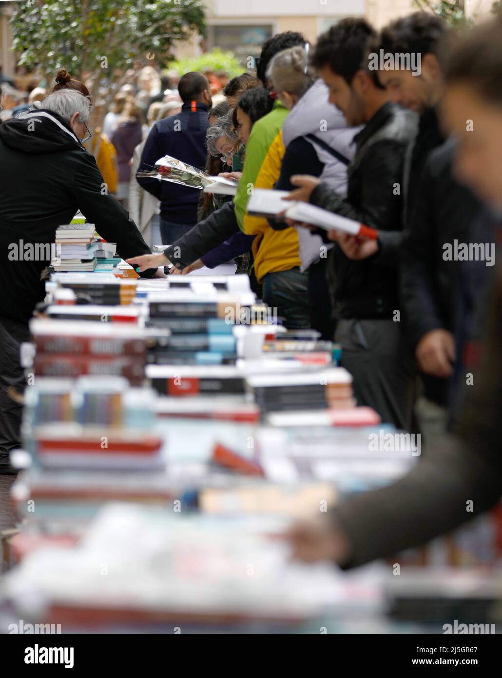 Palma, Spain. 23rd Apr, 2022. Passers-by browse books at a stall on Sant Miquel Street on Saint George's Day (George's Day). April 23 is celebrated worldwide Book Day, and in Mallorca it is typical for libraries to set up their stalls in the main streets. Credit: Clara Margais/dpa/Alamy Live News Stock Photo