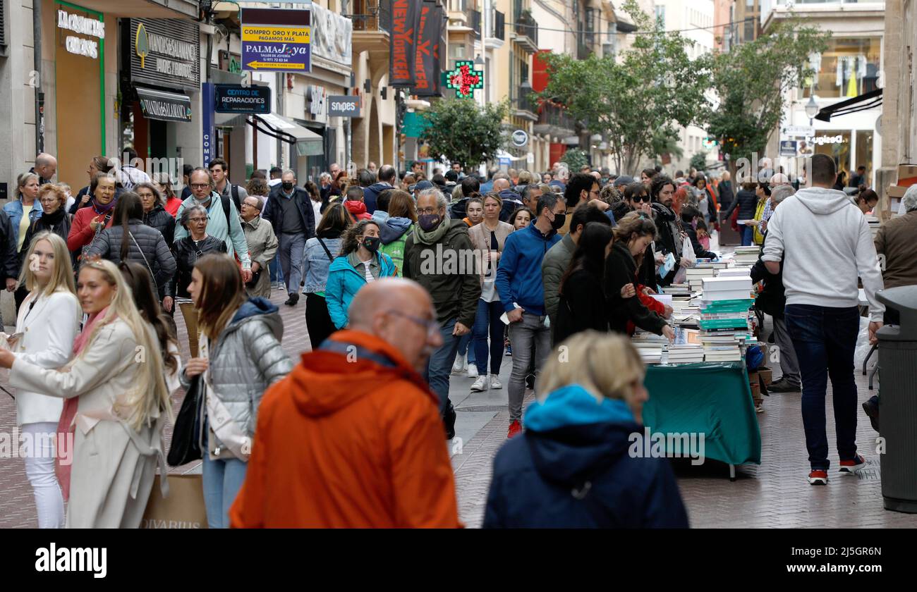 Palma, Spain. 23rd Apr, 2022. Passers-by browse books at a stall on Sant Miquel Street on Saint George's Day (George's Day). April 23 is celebrated worldwide Book Day, and in Mallorca it is typical for libraries to set up their stalls in the main streets. Credit: Clara Margais/dpa/Alamy Live News Stock Photo