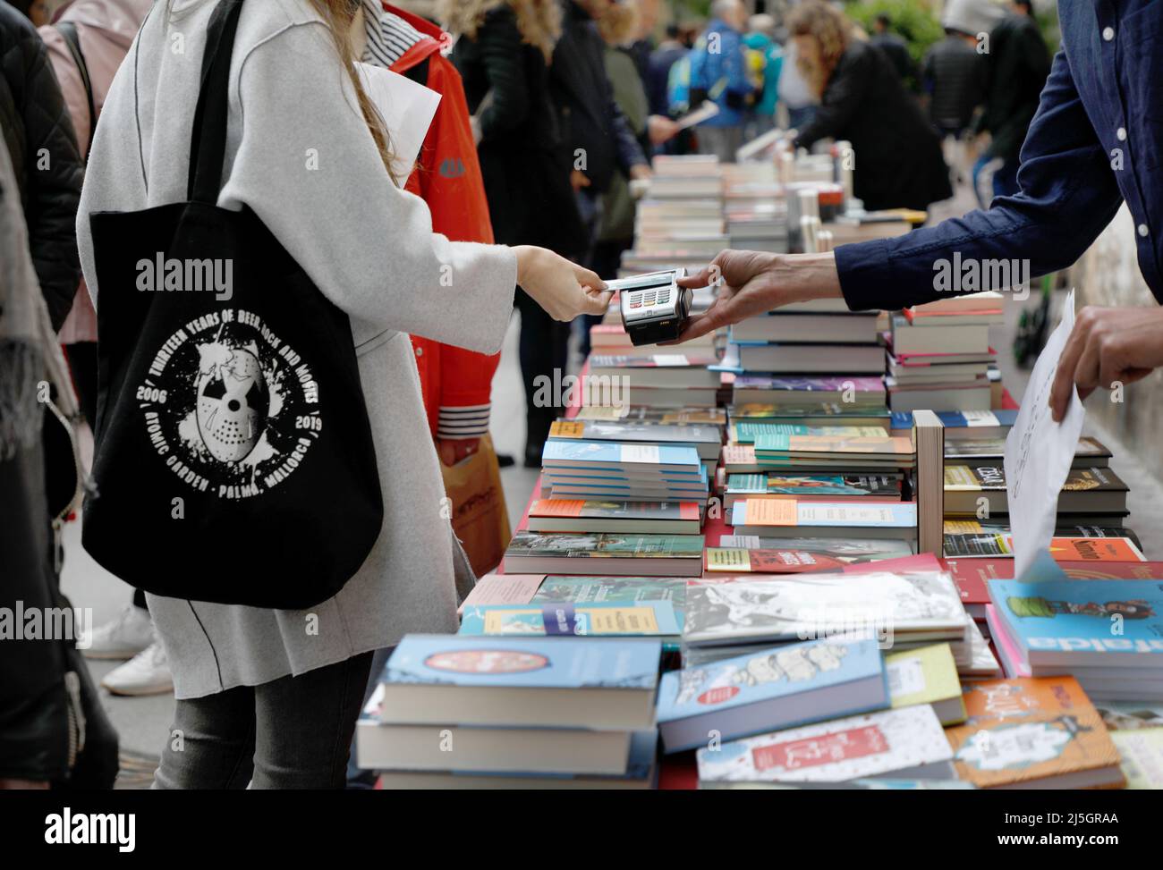 Palma, Spain. 23rd Apr, 2022. Passers-by browse books at a stall on Sant Miquel Street on Saint George's Day (George's Day). April 23 is celebrated worldwide Book Day, and in Mallorca it is typical for libraries to set up their stalls in the main streets. Credit: Clara Margais/dpa/Alamy Live News Stock Photo