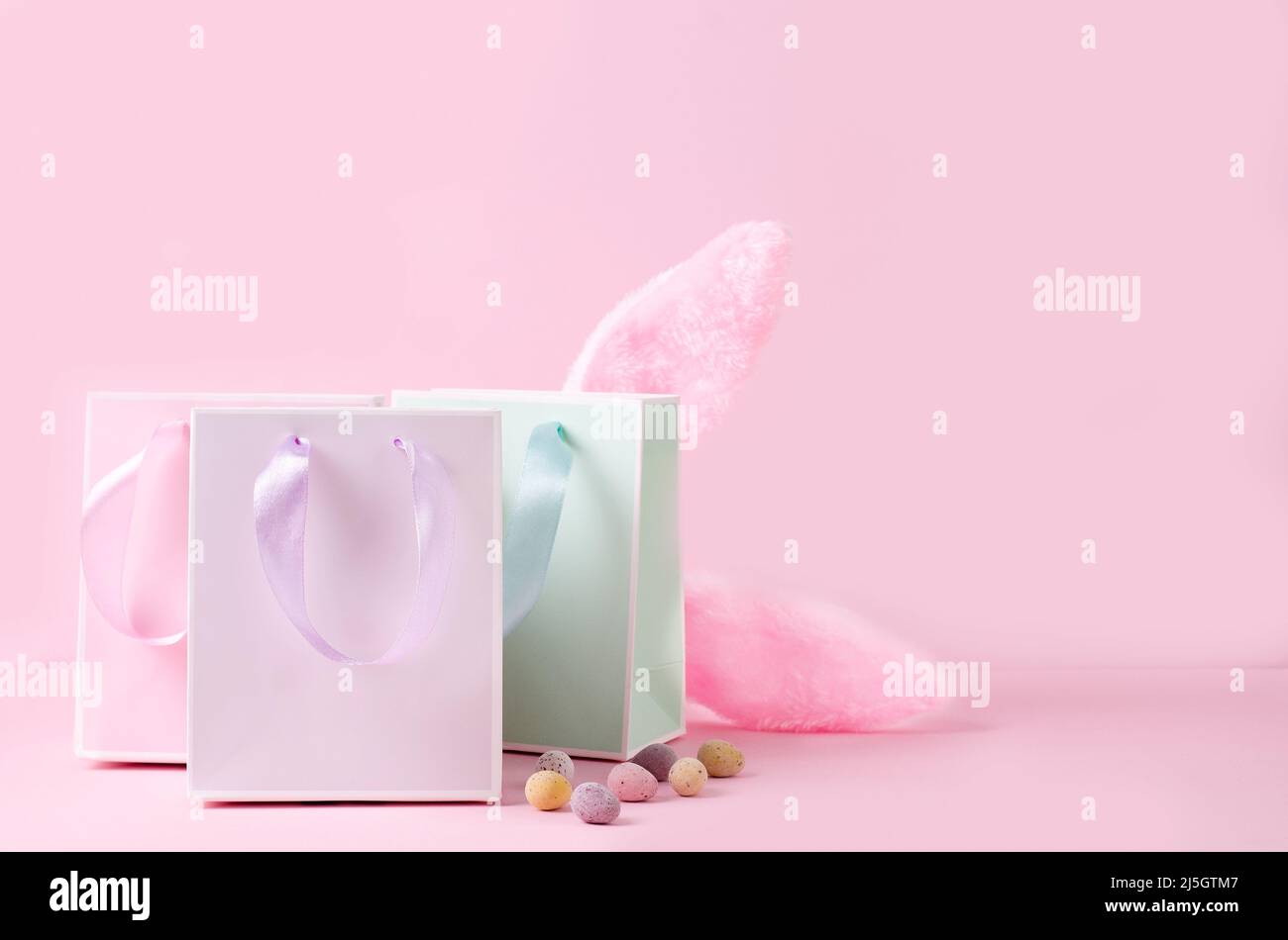 Easter shopping. Pastel color paper shopping bags on pink background ...