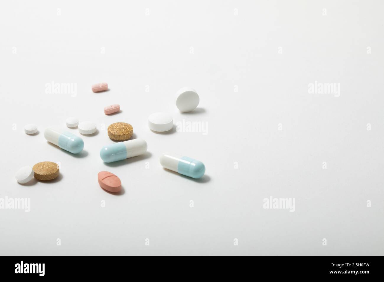 loose multi coloured tablets isolated on a white background Stock Photo
