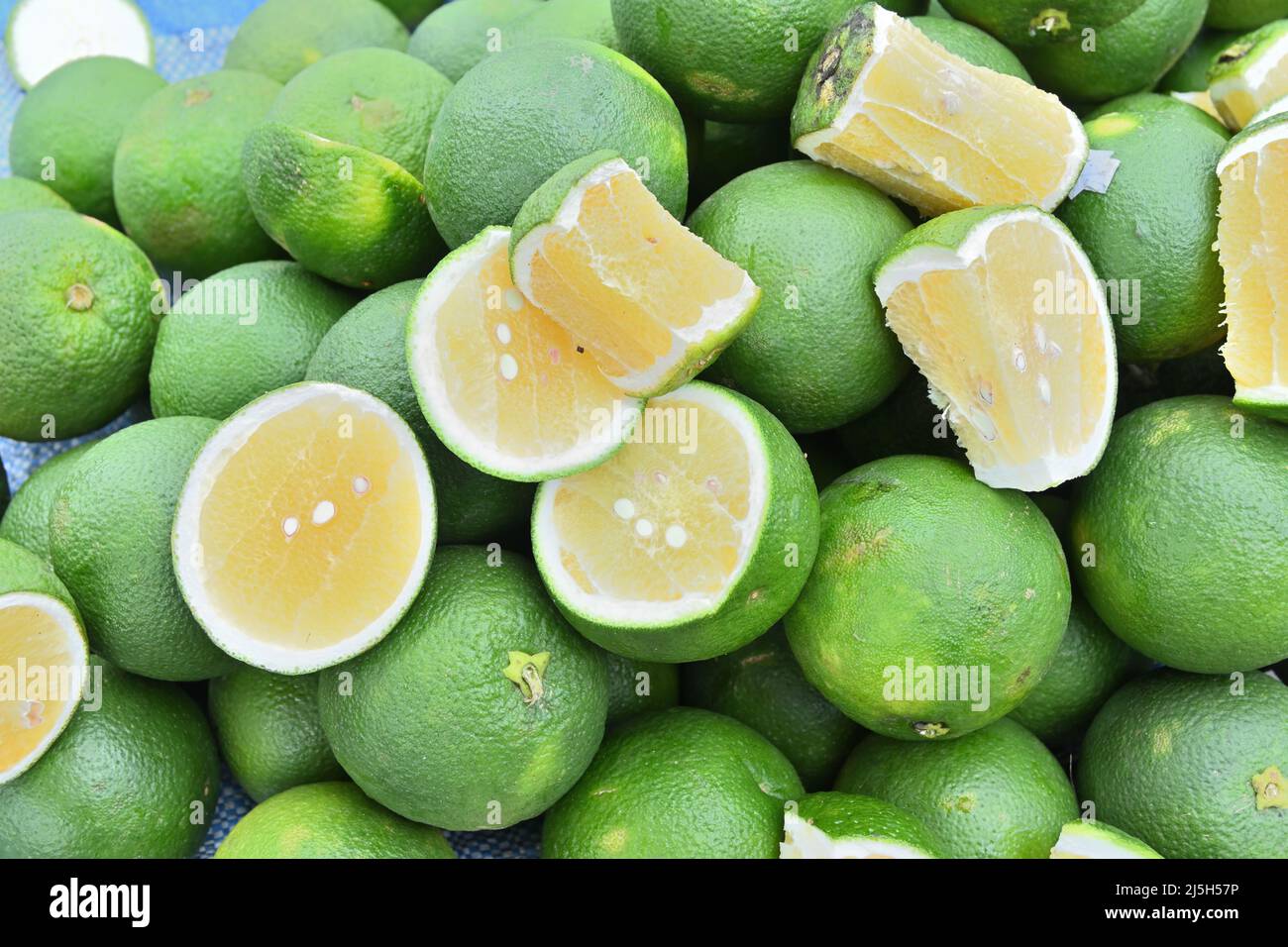 High angle view of slices Sweet Orange fruits and (Citrus sinensis) on top of pile of Sweet Orange fruits Stock Photo