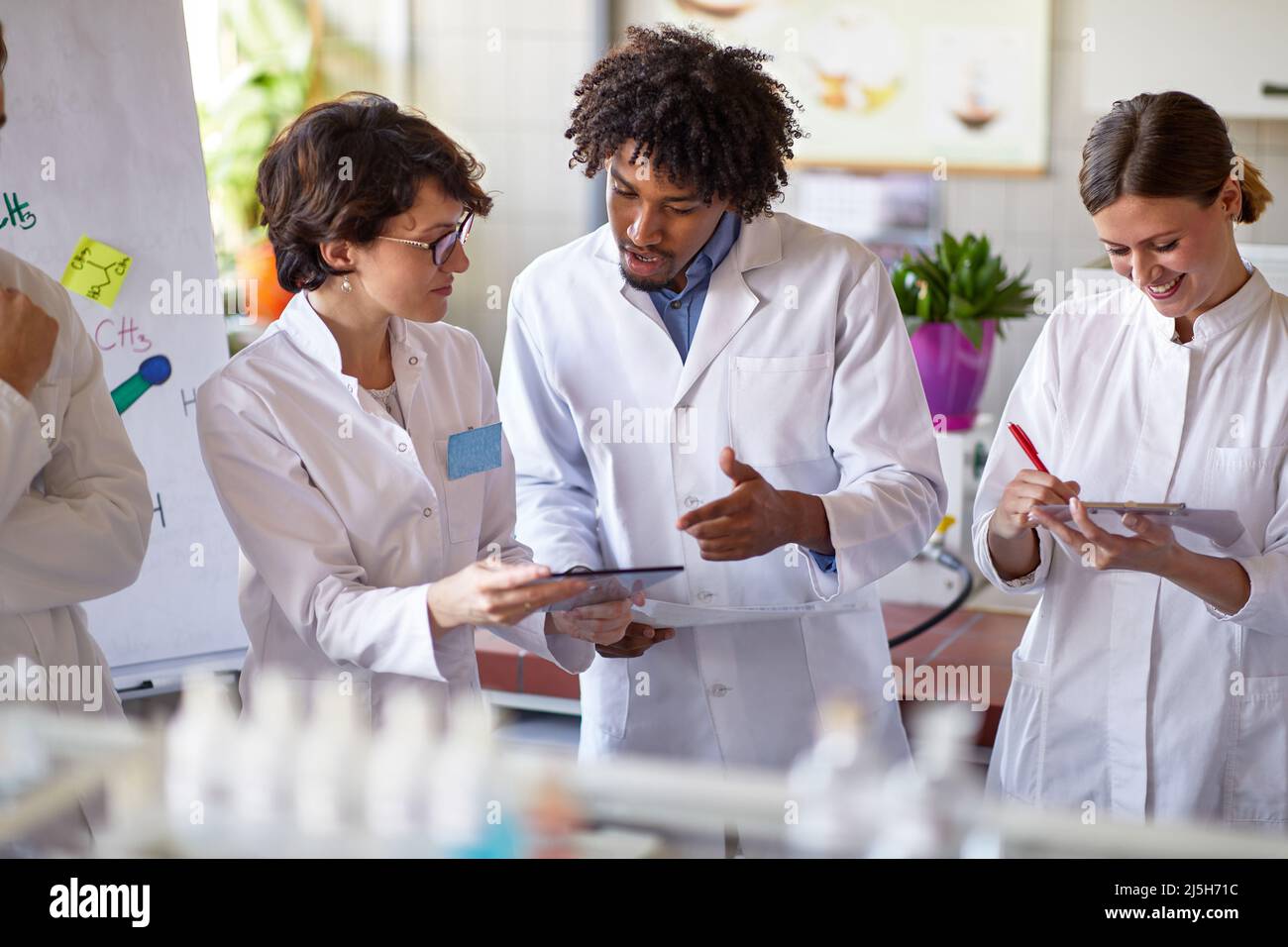 Group of young medical workers working in lab Stock Photo