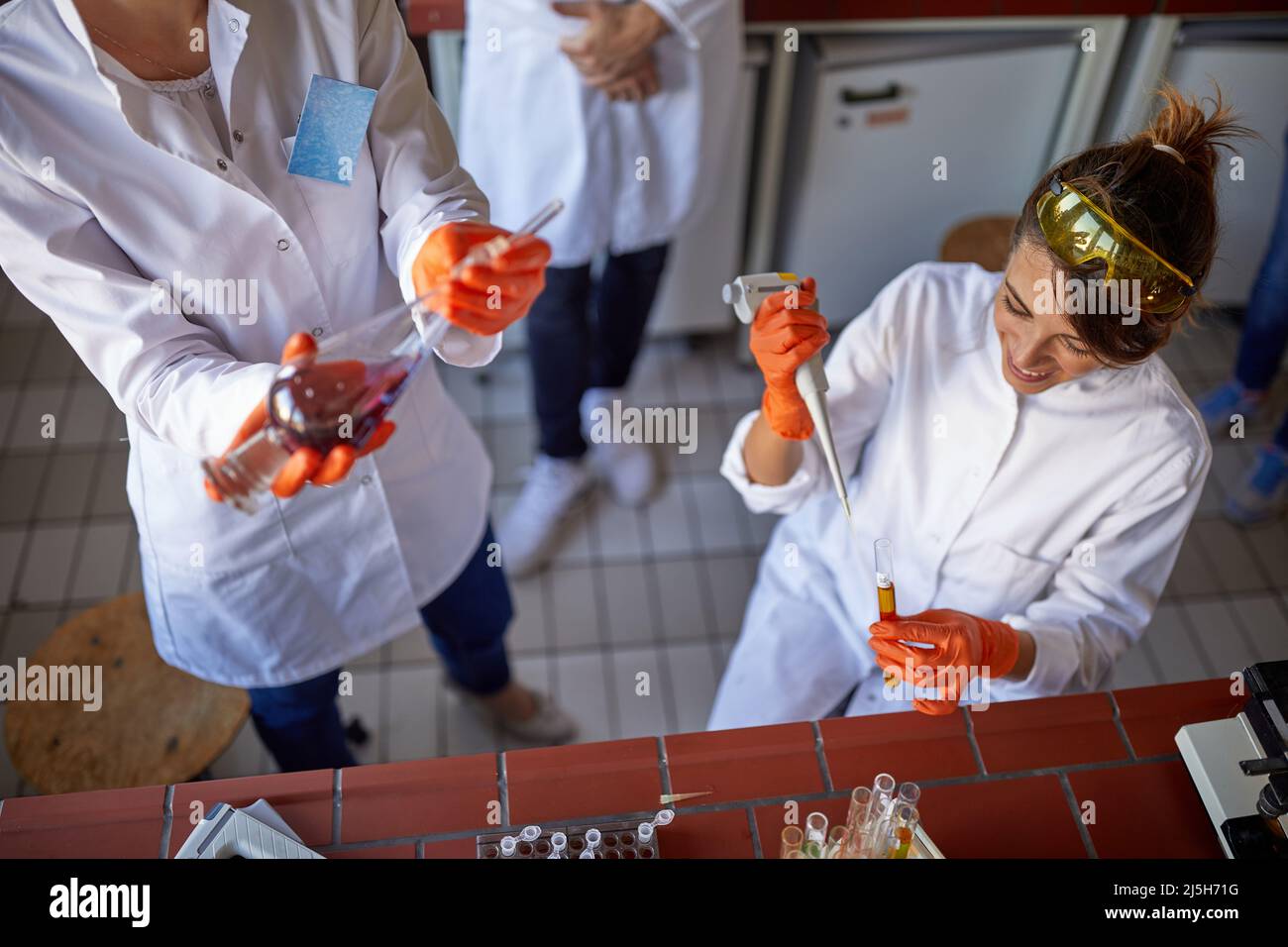 Young lab workers working with lab equipment Stock Photo