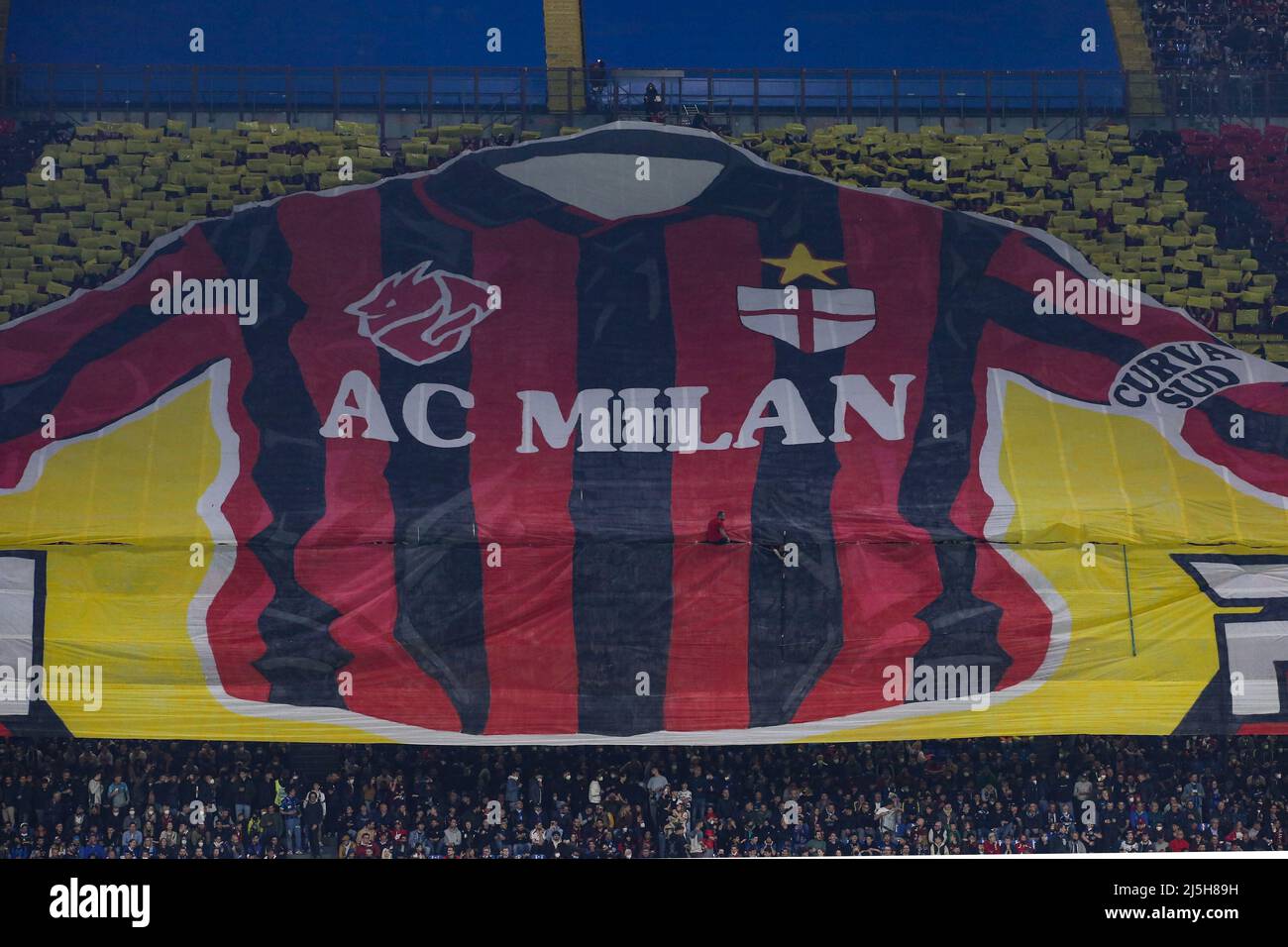 Milan, Italy, 19th April 2022. An AC Milan fan appears from in between the choreography during the Coppa Italia match at Giuseppe Meazza, Milan. Picture credit should read: Jonathan Moscrop / Sportimage Stock Photo
