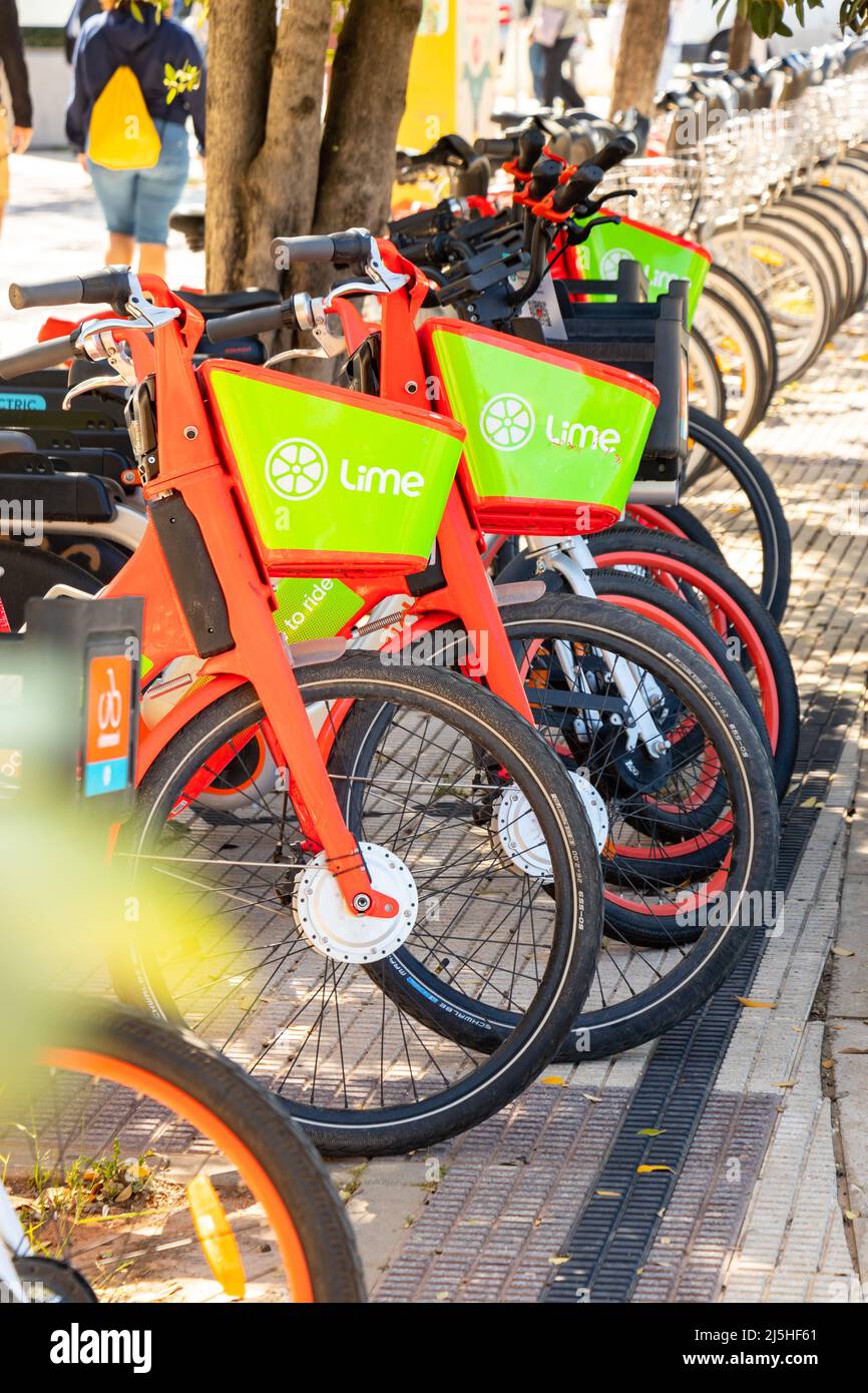 row or line of electric Lime bicycles for hire and rental in Seville  Sevilla spain Stock Photo - Alamy