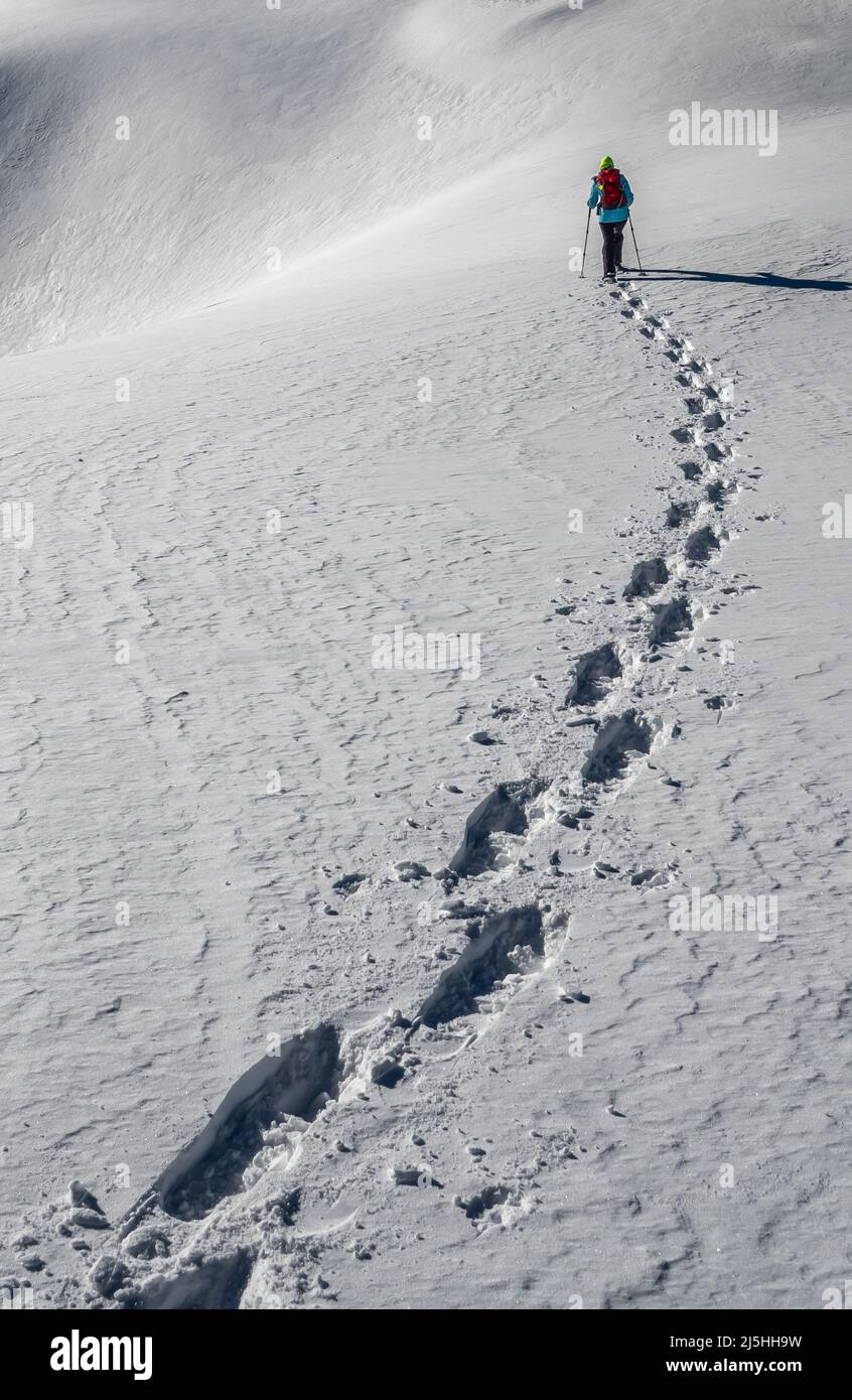 Sporty Hiking Woman With Snowshoes On A Trail Through Winter Landscape On Mountain Rax In The